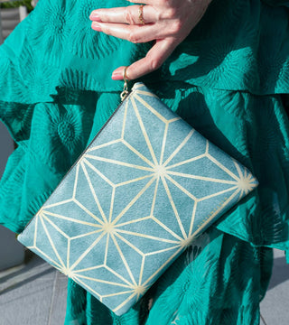 Woman holding a Starburst Nappa Leather Large Clutch 